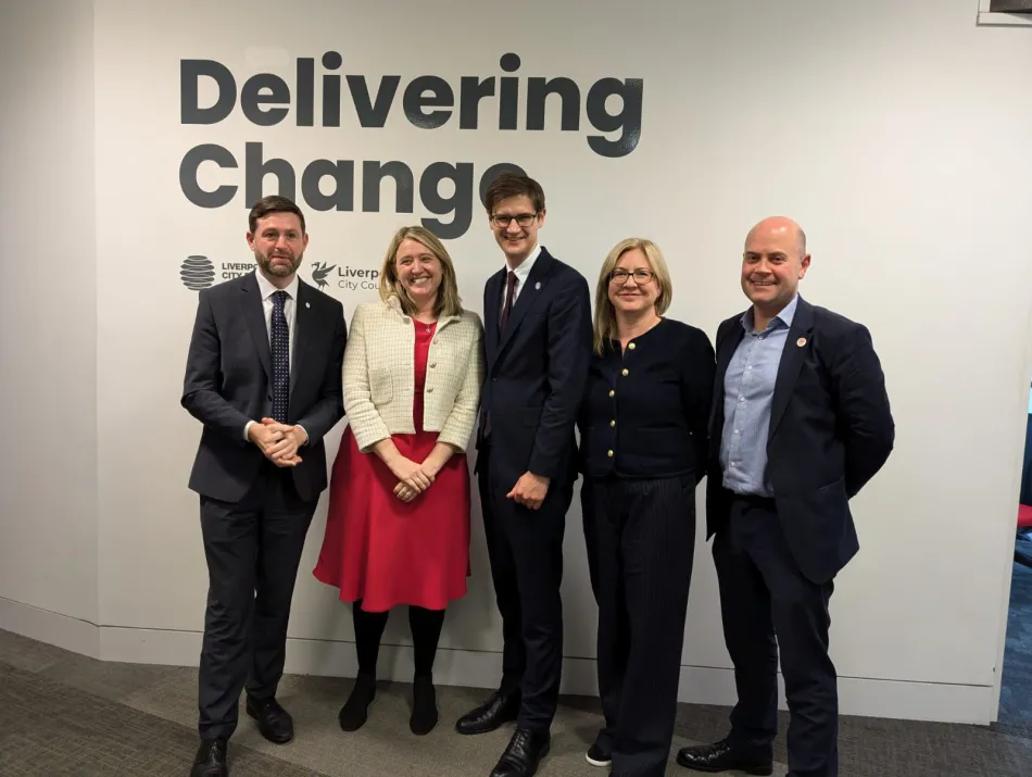 group in front of delivering change banner