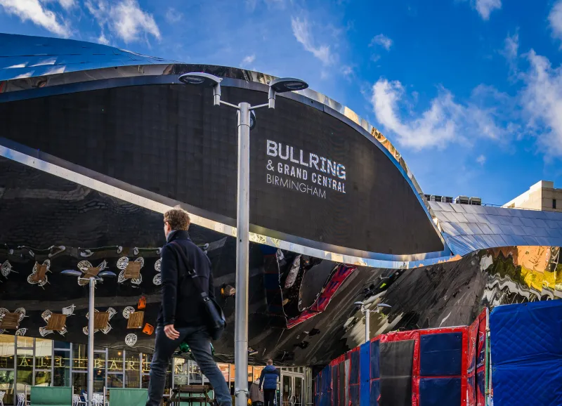 Man walking in front of the Bullring shopping centre