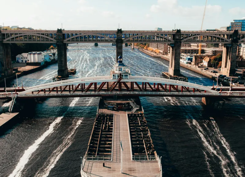  gray concrete bridge over body of water during daytime