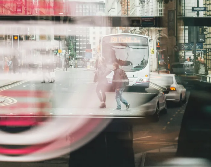 two people walking on road near bus